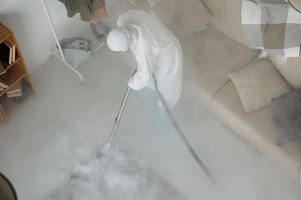 Biohazard cleanup technician in protective equipment, Pleasanton, KS